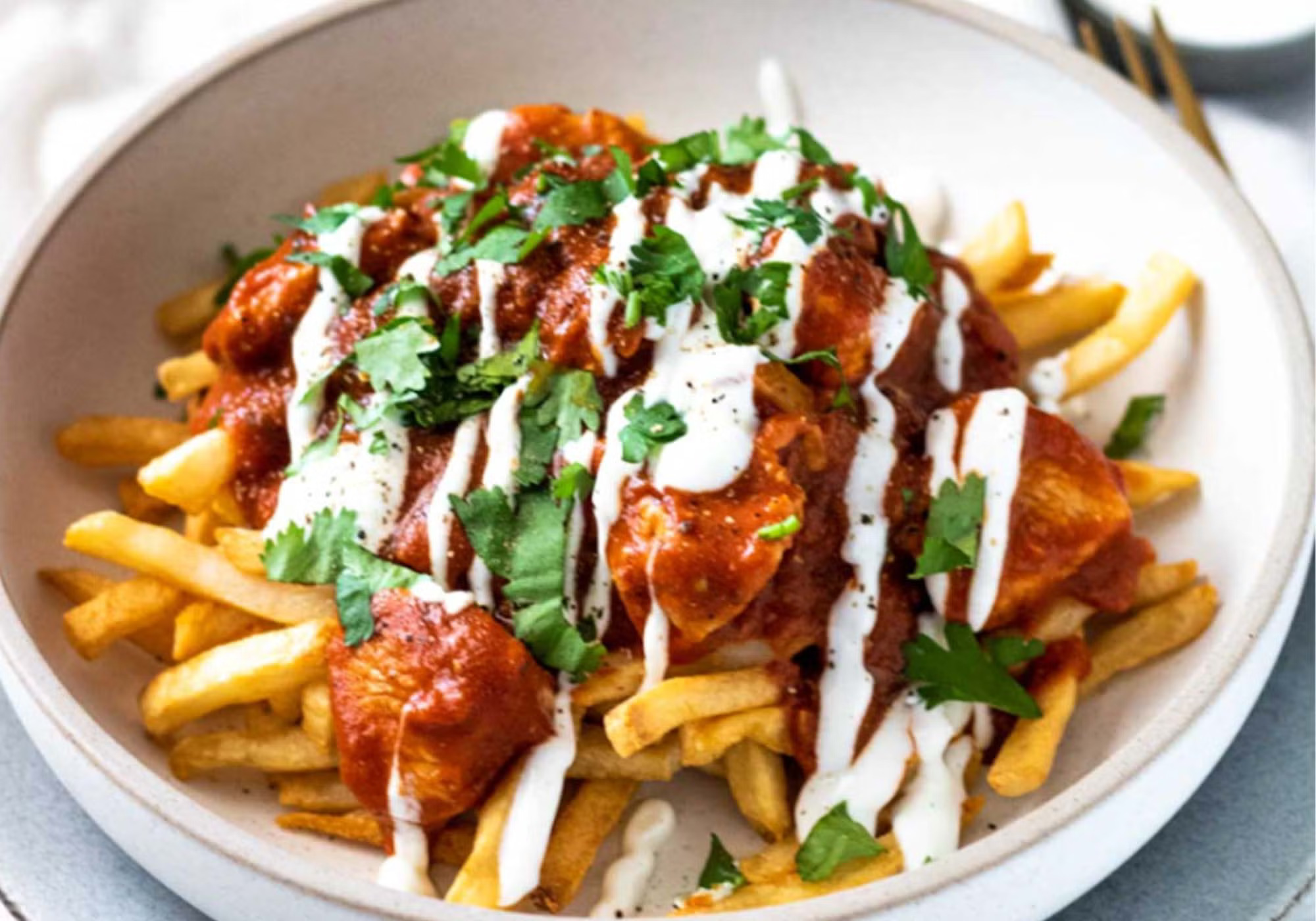 Best Butter Chicken Poutine in Ottawa with crispy fries, cheese curds, and rich butter chicken sauce