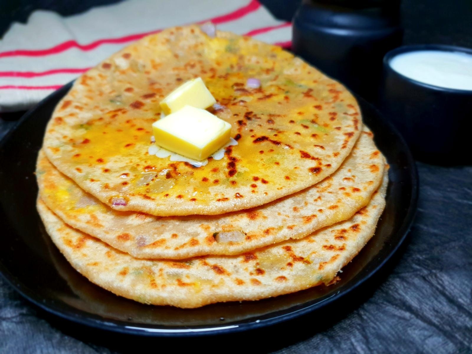 Hot and crispy Paneer Paratha served with butter and chutney in Ottawa